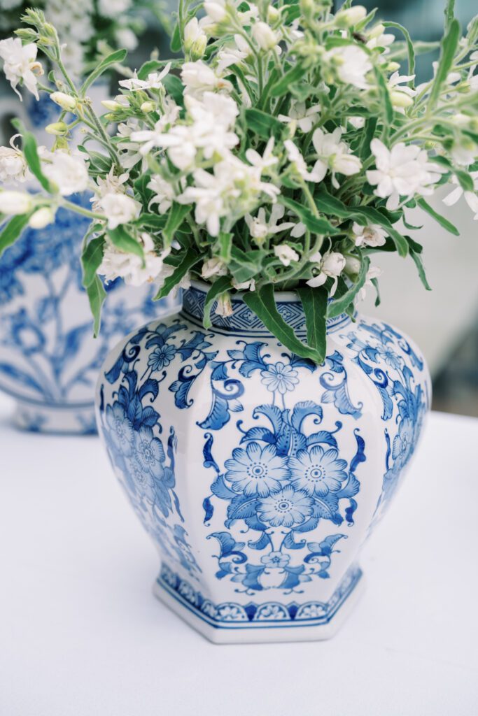 showing the details of the blue and white decorative vases holding the florals at the cocktail hour