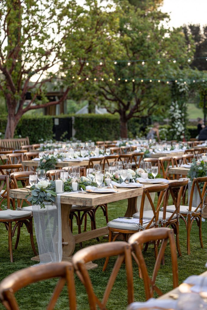 a wedding reception dinner is taking place outdoors on grass in san diego california at a gorgeous wedding venue
