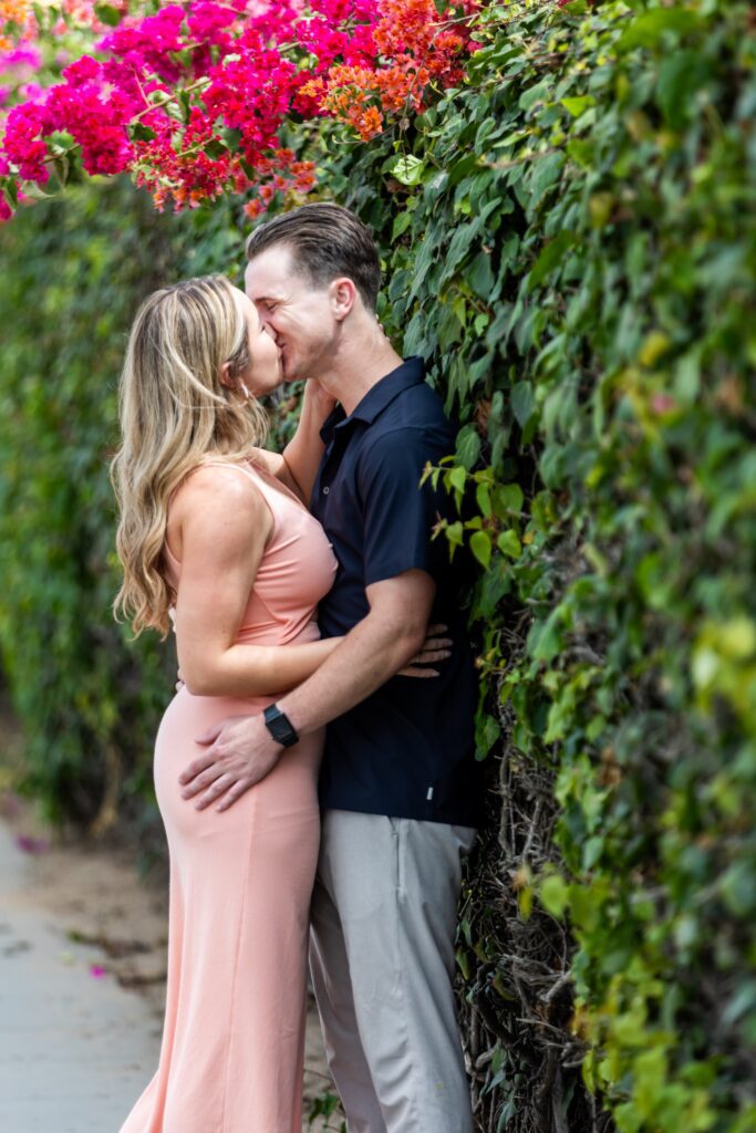 Newly engaged couple kissing and demonstrating our engagement photo tips and styling advice